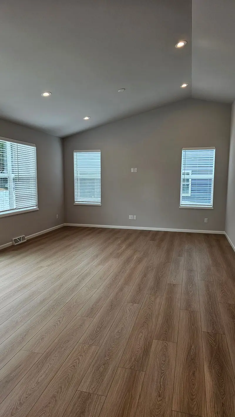 Newly installed flooring in a freshly painted room — R&L project