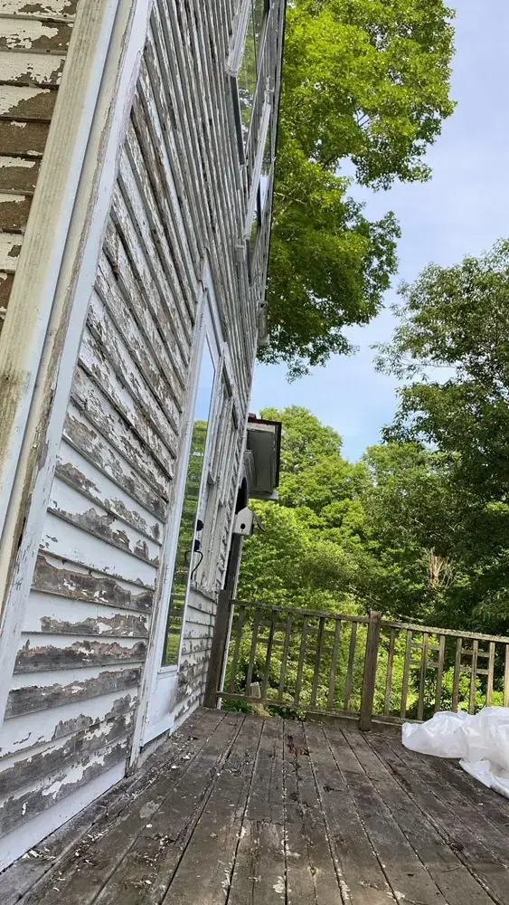 Two-story home construction project in progress with new deck framing