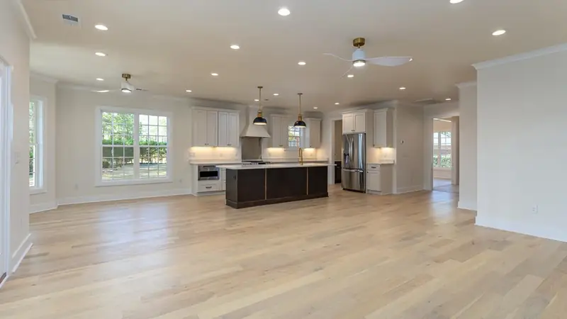 Open-concept living space with kitchen island and light wood floors