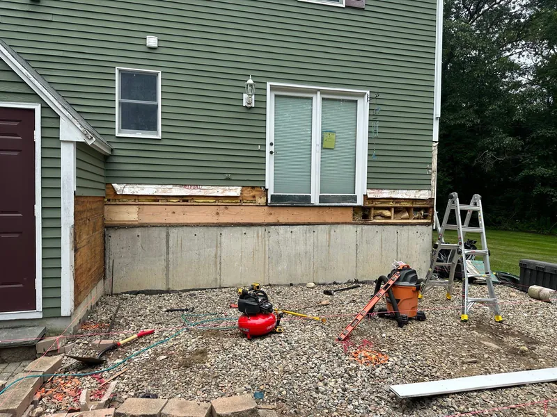 Backyard before the deck — bare concrete foundation and tools