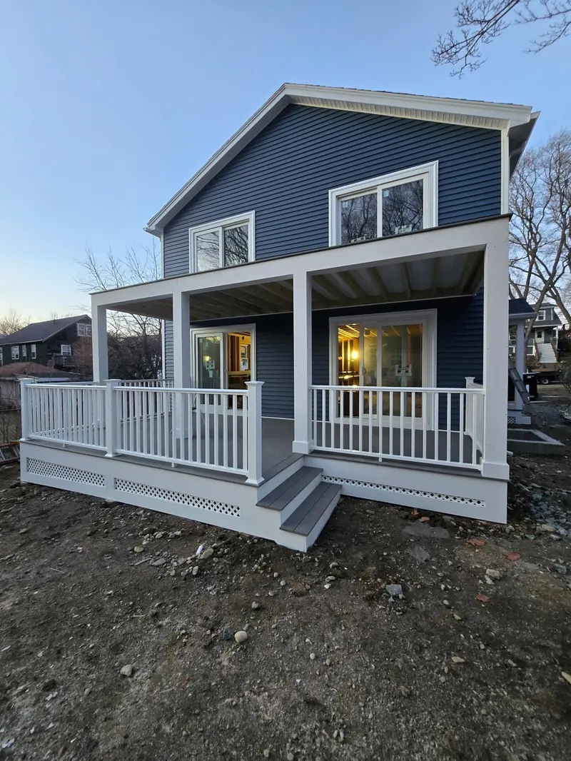 Farmer's porch on a blue colonial — white railings — R&L project