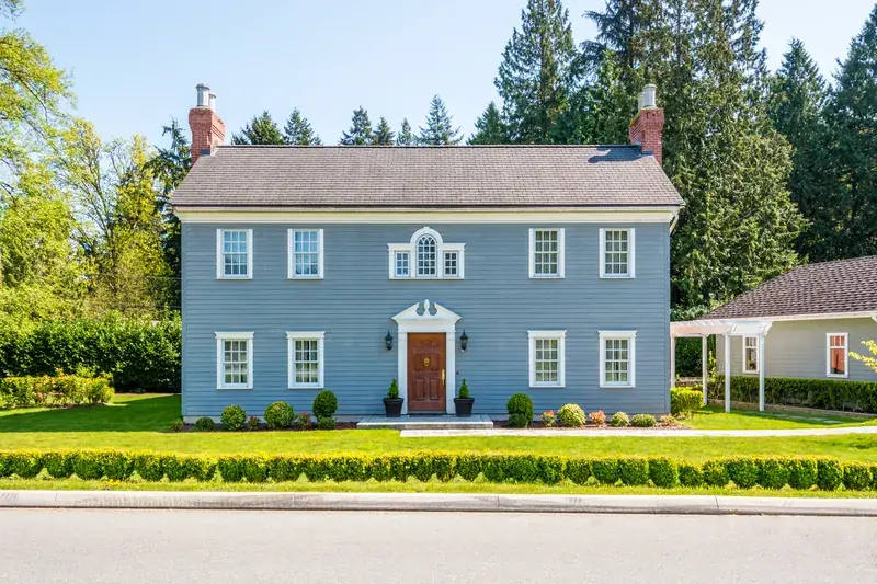 Blue colonial home with symmetrical double-hung windows