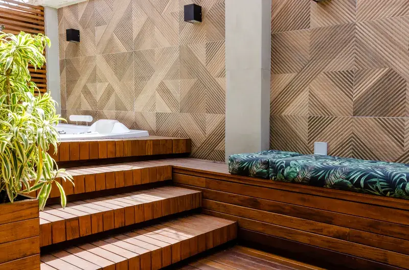 Wood deck with built-in hot tub and stairs in a backyard