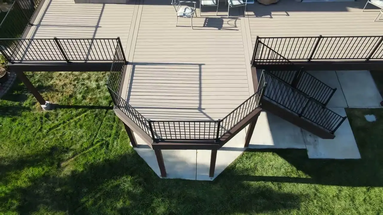Wood deck with built-in hot tub and stairs in a backyard